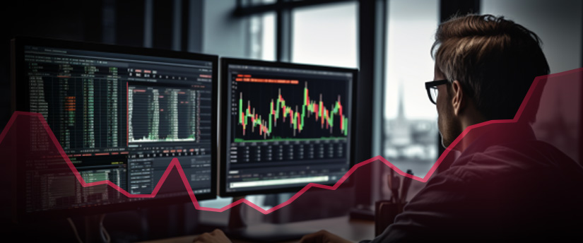 A CFD trader checks and analyzes the market on their monitors before starting to trade.