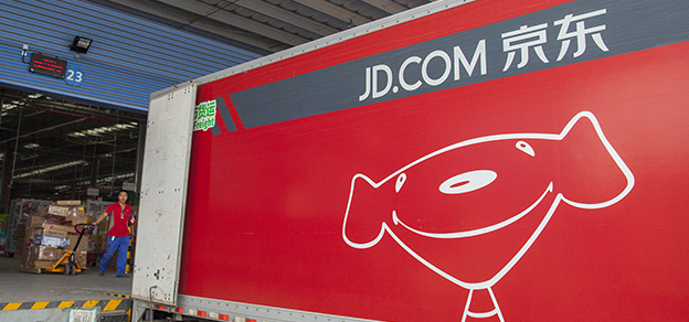 An image of a truck inside a warehouse,  symbolizing the JD logo - a dog on a truck.