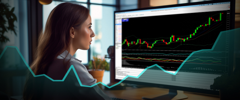 Une femme analyse un graphique boursier sur un écran d'ordinateur, en se concentrant sur le cfd, le courtier et le trading, avec un homme à proximité.