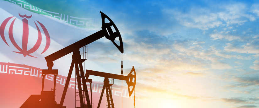 An oil pump stands prominently in a vast field, symbolizing energy production amidst natural surroundings.
