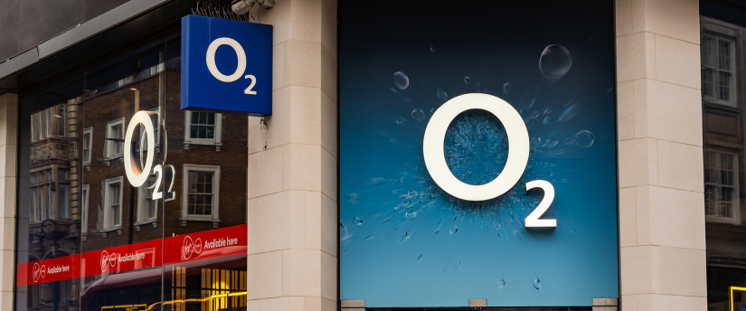 A building showcases the O2 logo on its side, highlighting the brand's presence.