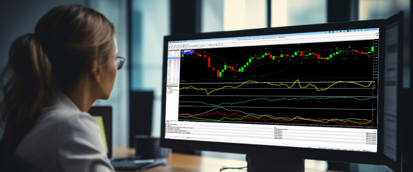 A woman focuses on a computer screen that features a trading chart, engaged in market analysis and decision-making.