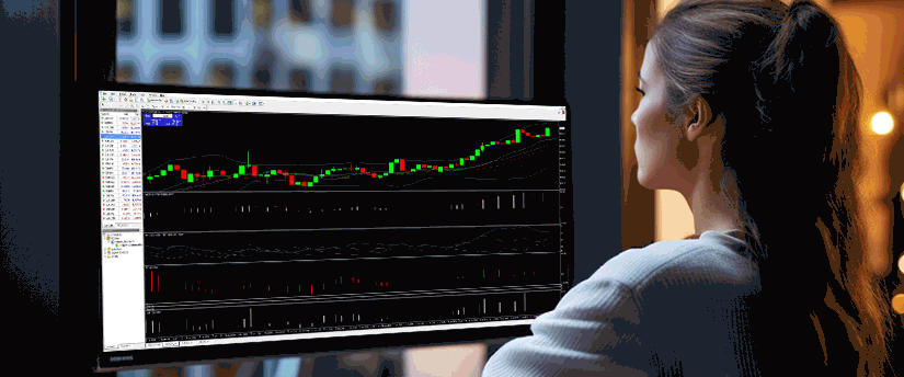 A focused woman examines a trading chart on a screen, engaged in financial analysis and decision-making.