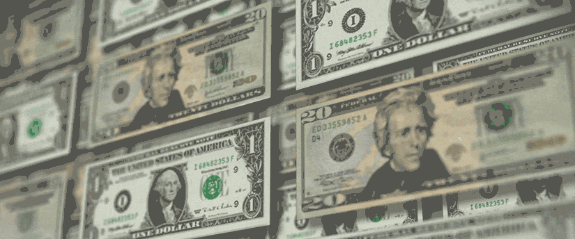 A close-up view of a neatly arranged stack of various denominations of currency bills.