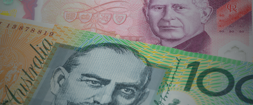 Image of Australian dollar notes alongside multiple U.S. dollar bills, illustrating currency comparison.
