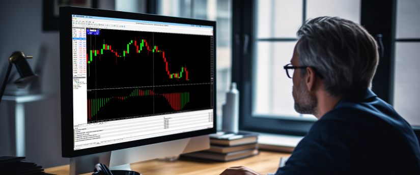 A man focused on a computer screen showing a trading indicator, emphasizing consistent forex trading strategies.