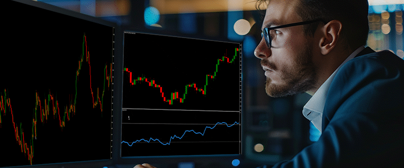 Side view of a male trader in glasses examining real-time data and charts for popular cryptocurrencies in a modern trading office.